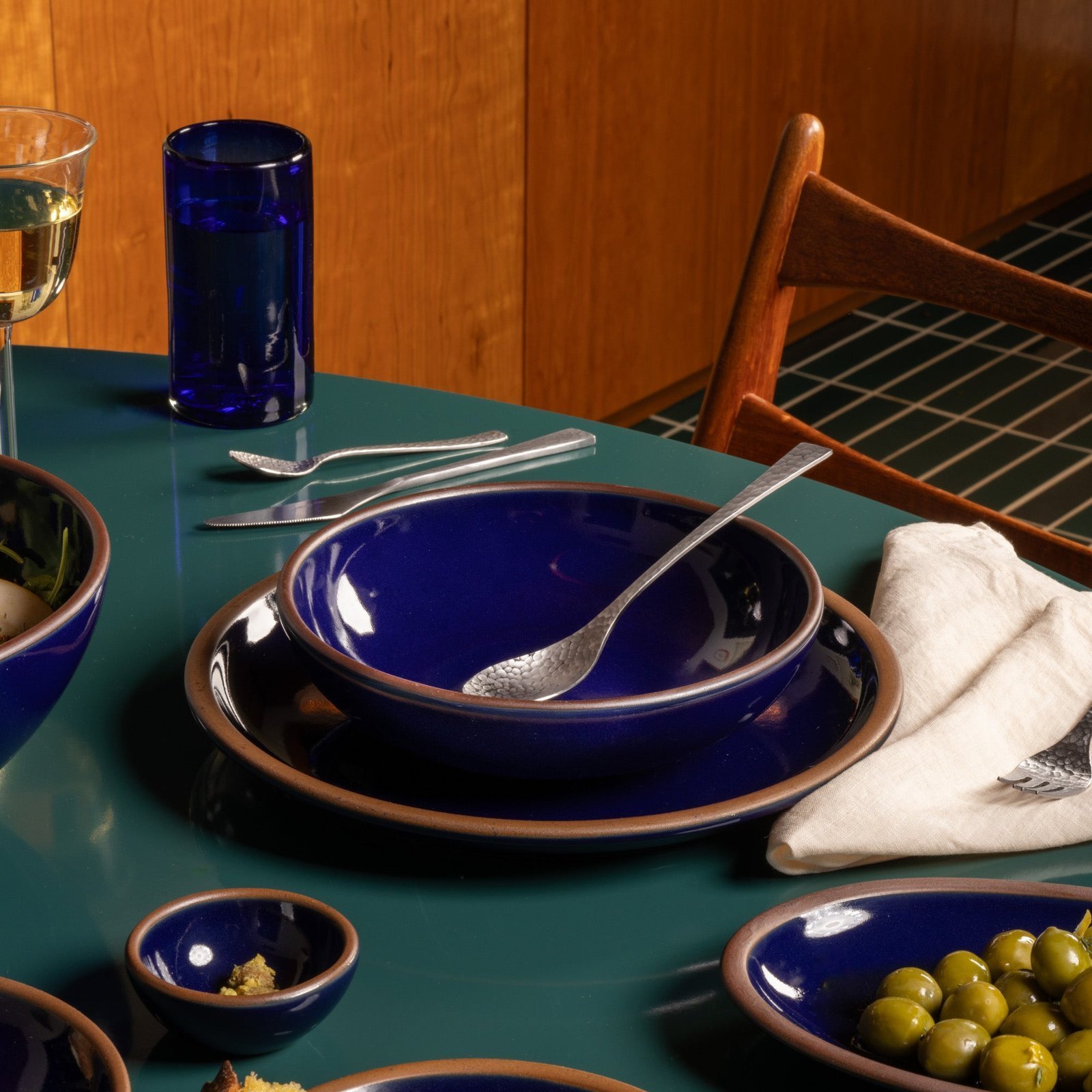 Lunessia daily bowl in Midnight Navy, in a table setting with other dinnerware