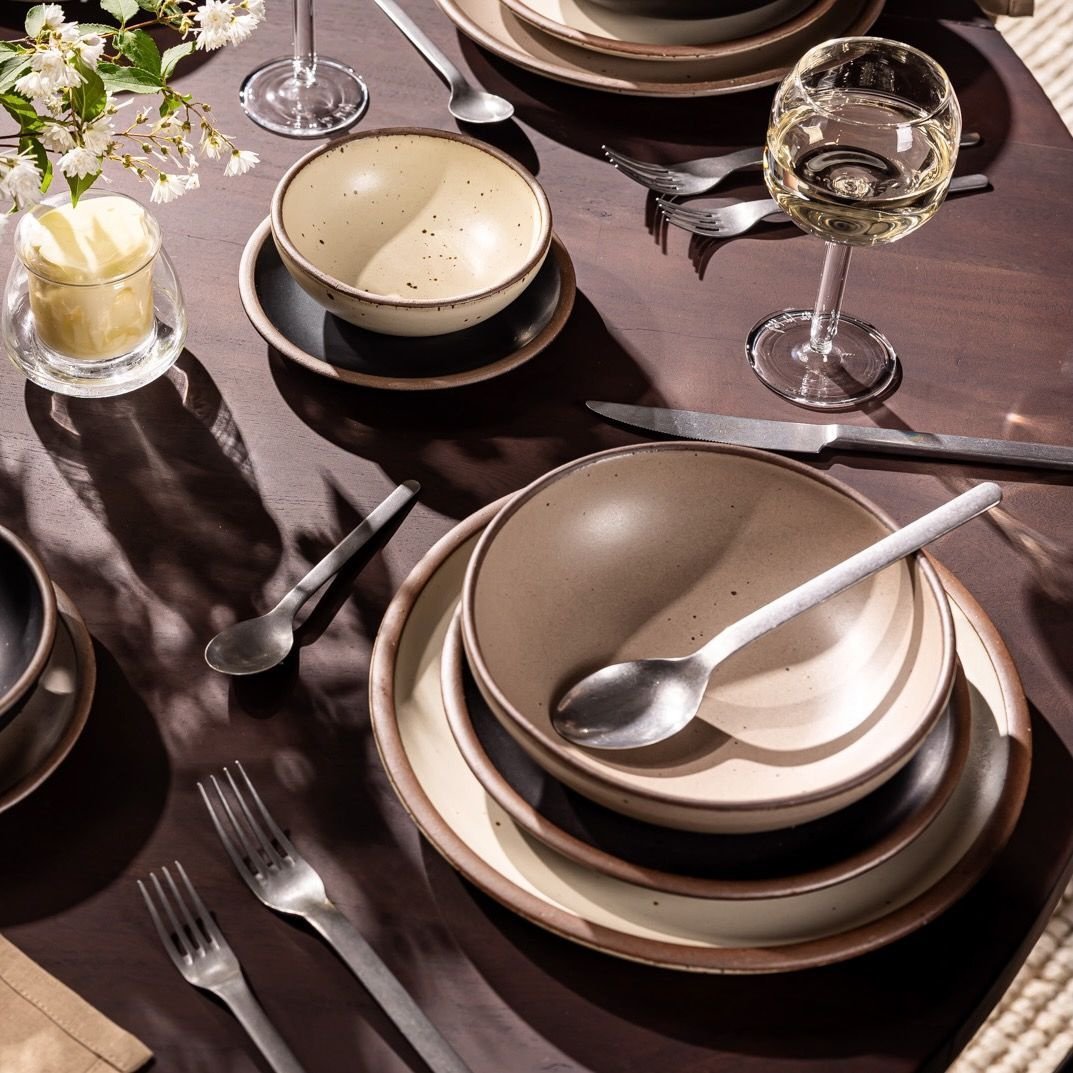 Lunessia daily bowl in Warm Taupe, in a table setting with other dinnerware
