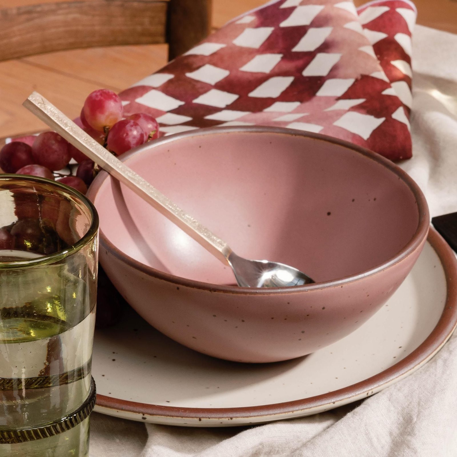 Lunessia soup bowl in Lilac, in a table setting with other dinnerware