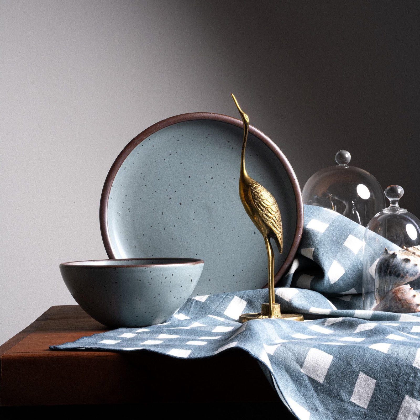 Lunessia soup bowl in Mist Blue, in a display with other tableware