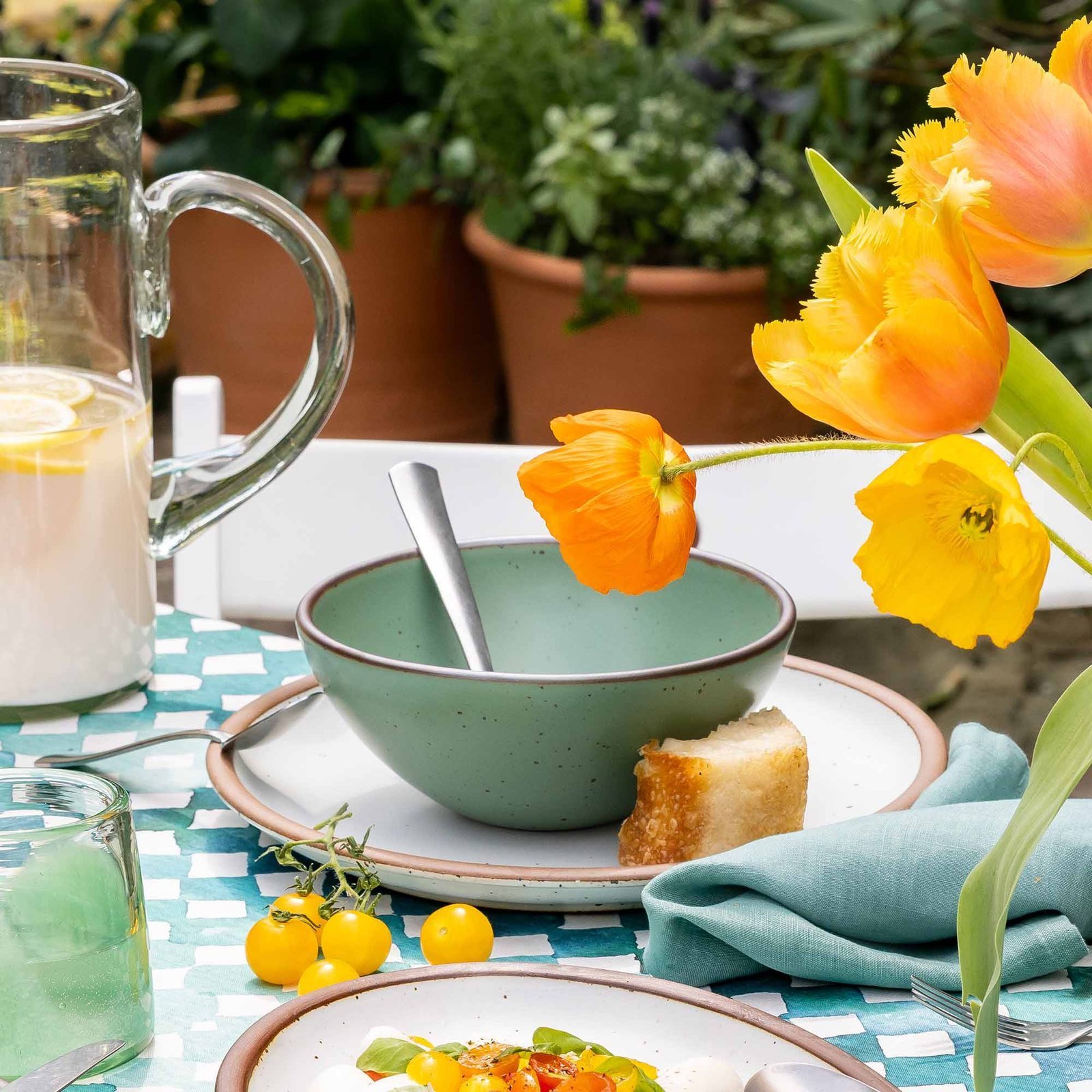 Lunessia soup bowl in Viridian, in an outdoor table setting